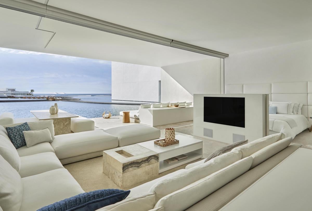 interior view of living room with balcony and ocean in background