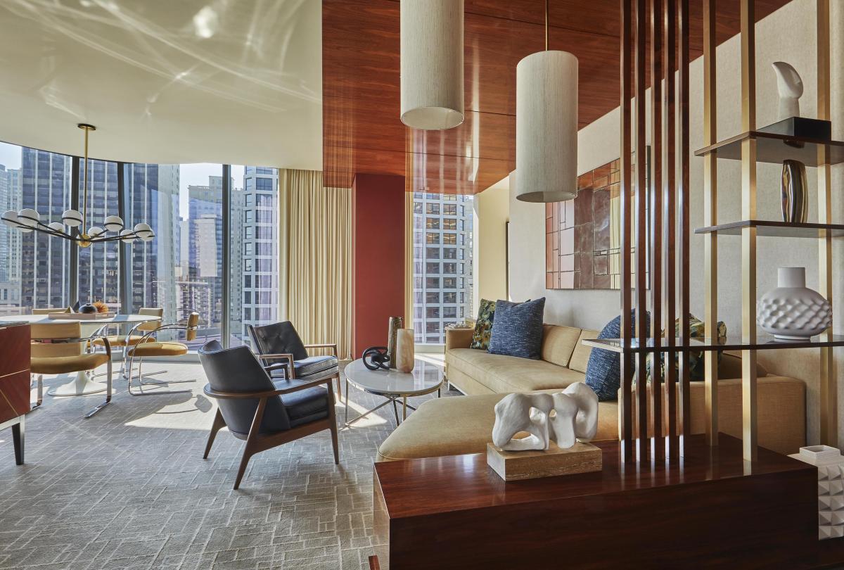 Large living room area with floor to ceiling windows