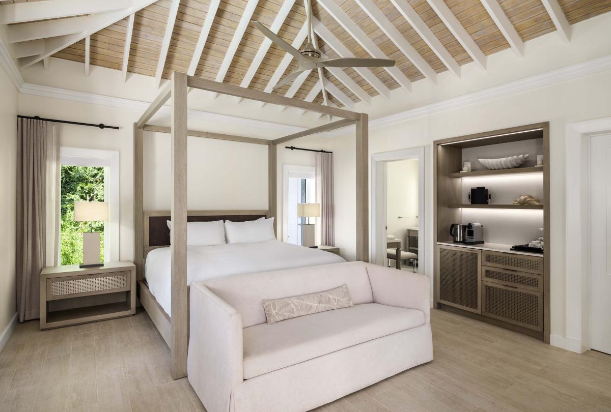 Bedroom with four post bed and couch