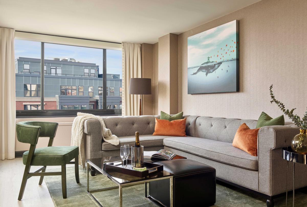 Living room with small sectional and green suede chair