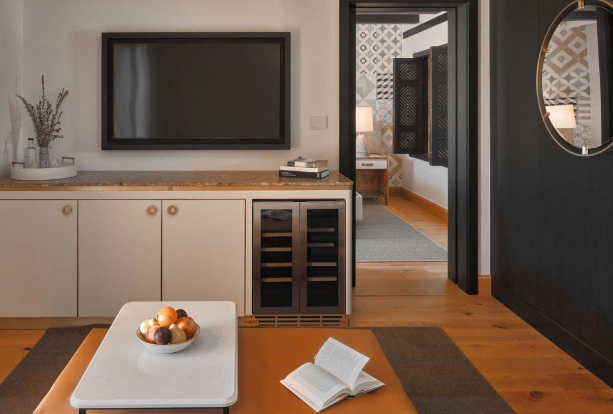 A coffee table, credenza with a tv on top in a one bedroom suite at Viceroy Ombria Algarve