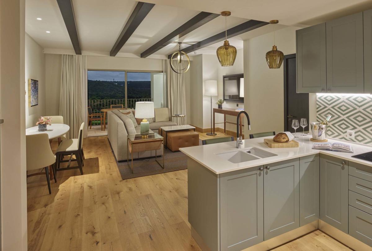 A spacious open kitchen into living room area overlooking a terrace in a residence at Viceroy Ombris Algarve