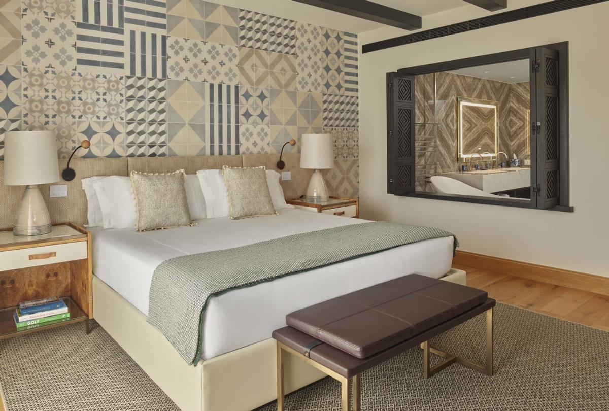 A warm bedroom with large bed in a two bedroom residence at Viceroy Ombria Algarve