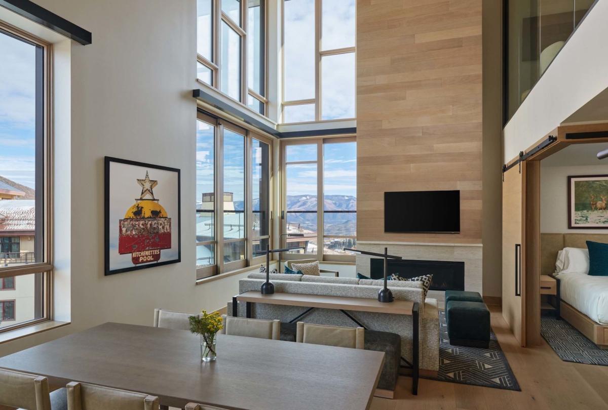 The dining space and living room in a Cirque Two Bedroom Penthouse Loft at Viceroy Snowmass