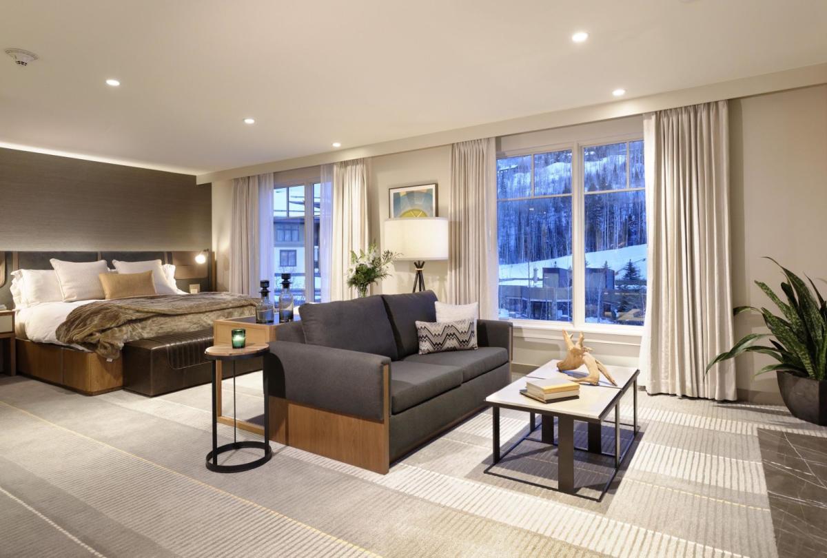 Bedroom with couch and fireplace at Viceroy Snowmass