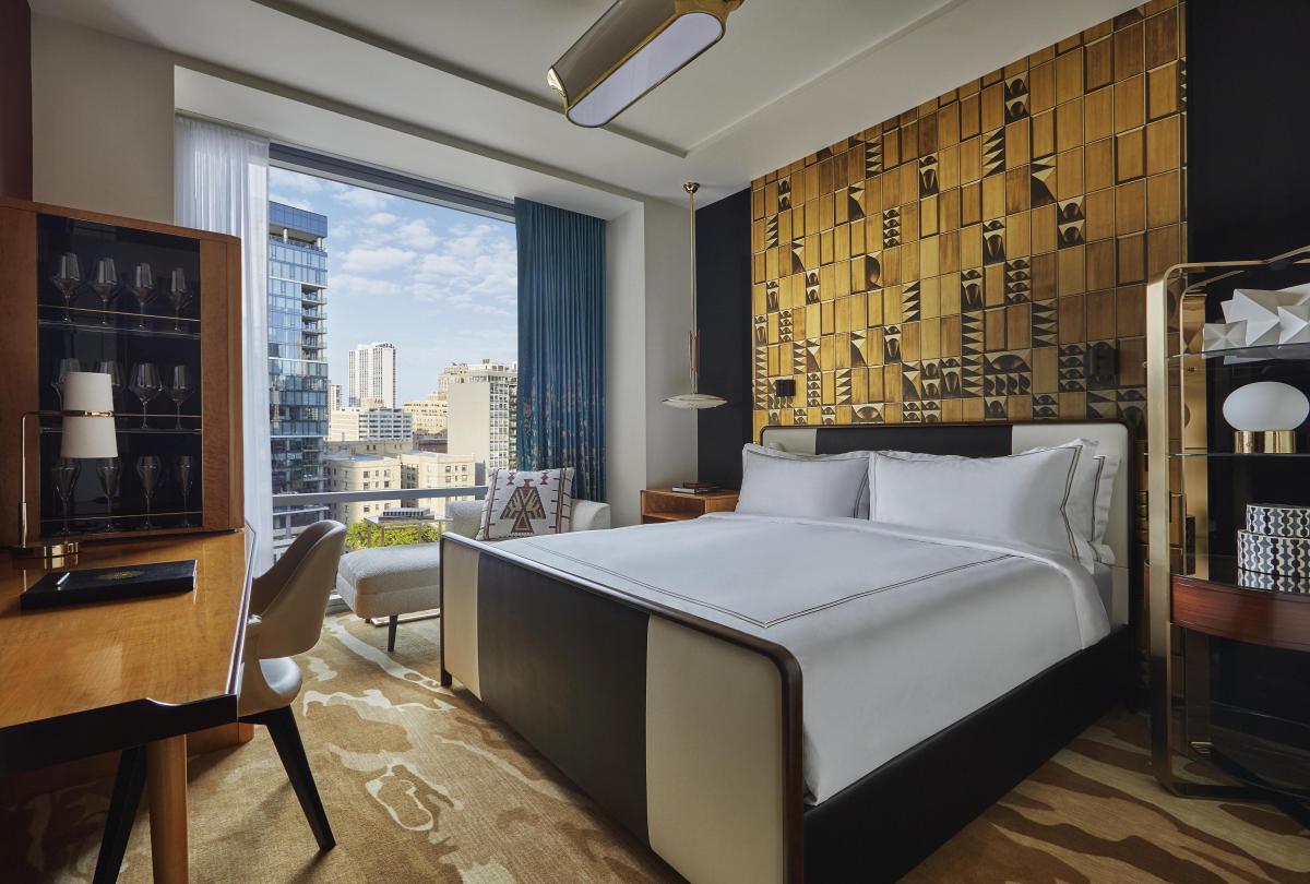 A king bed in a Viceroy Chicago hotel room with a City ciew