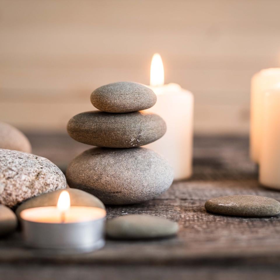 candles and rocks sit on a table