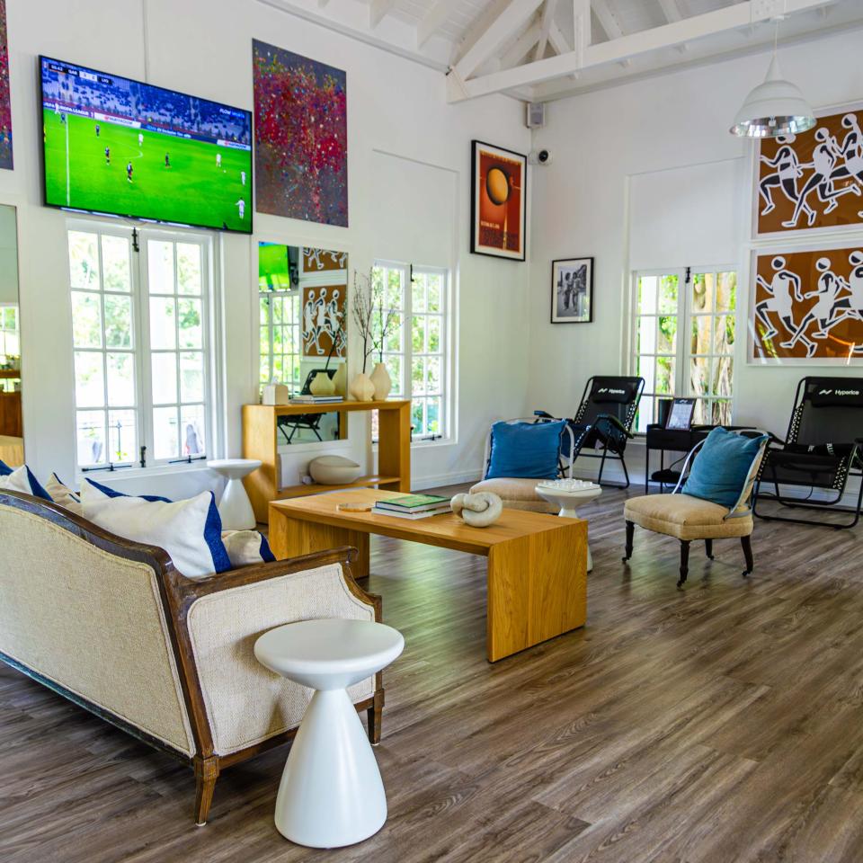 windowed room with TV and comfy furniture