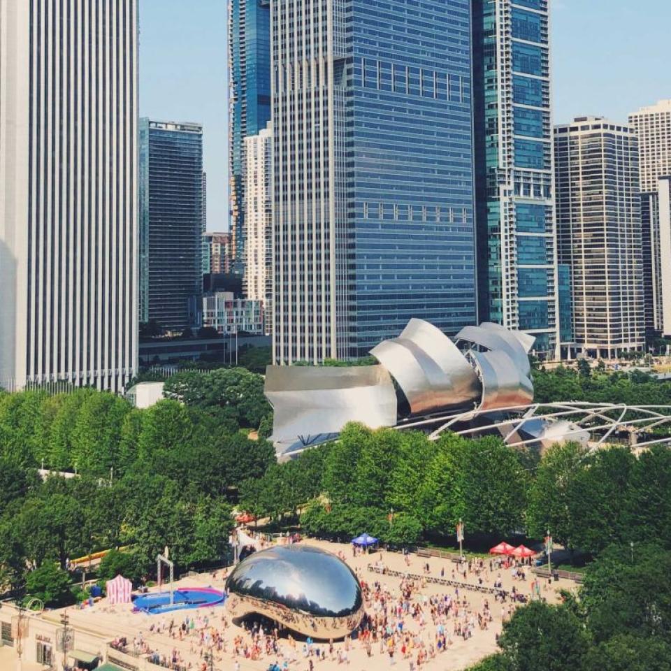 An aerial view of downtown Chicago, with the Bean and numerous large skyscrapers in view