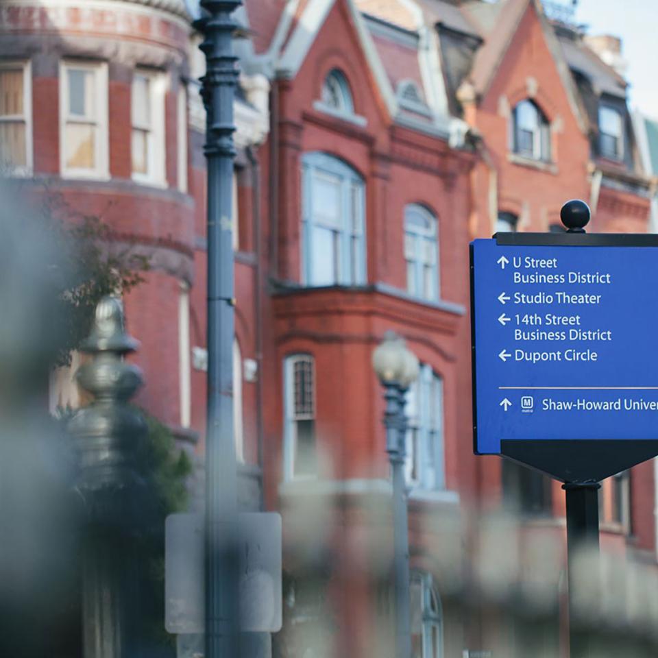 Street sign in front of red brick townhouses along Washington, DC's 14th Street Corridor