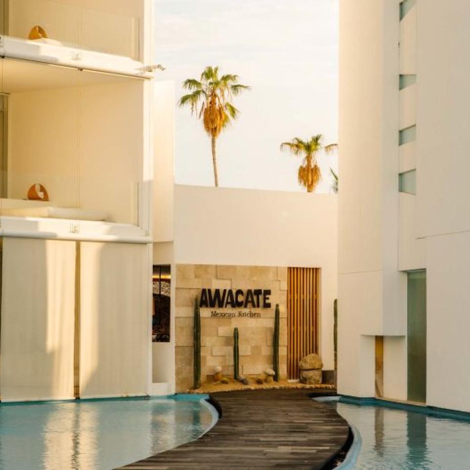 The exterior of Awacate restaurant at Viceroy Los Cabos, at the end of a pathway between two ponds