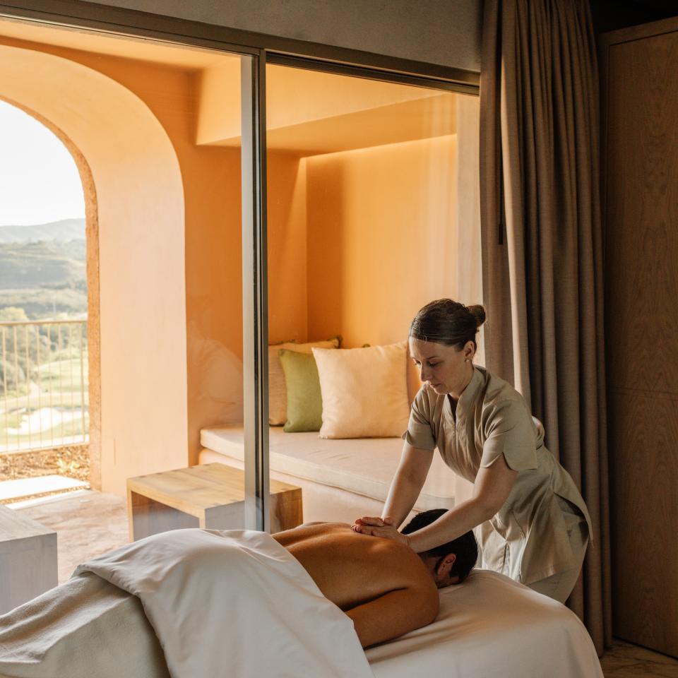 A person receiving a massage in a Viceroy Ombria Algarve hotel room