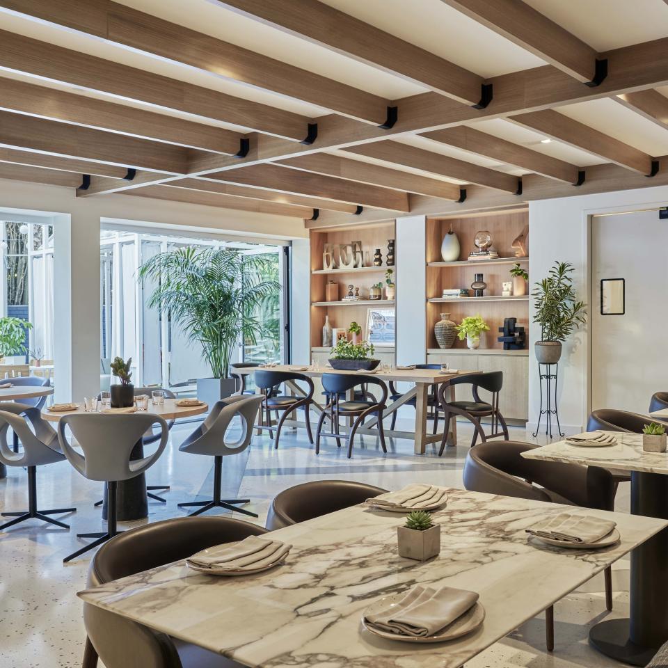A bright dining room with slatted ceilings