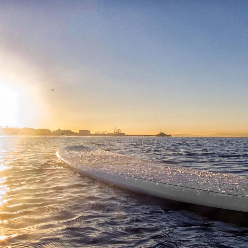 A paddleboard on the ocean at sunset