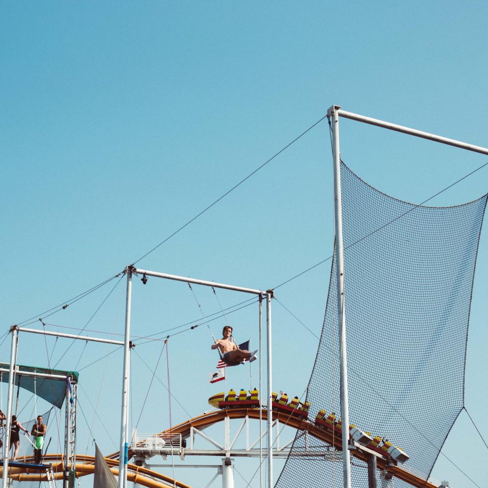 A person practices swinging on a trapeze