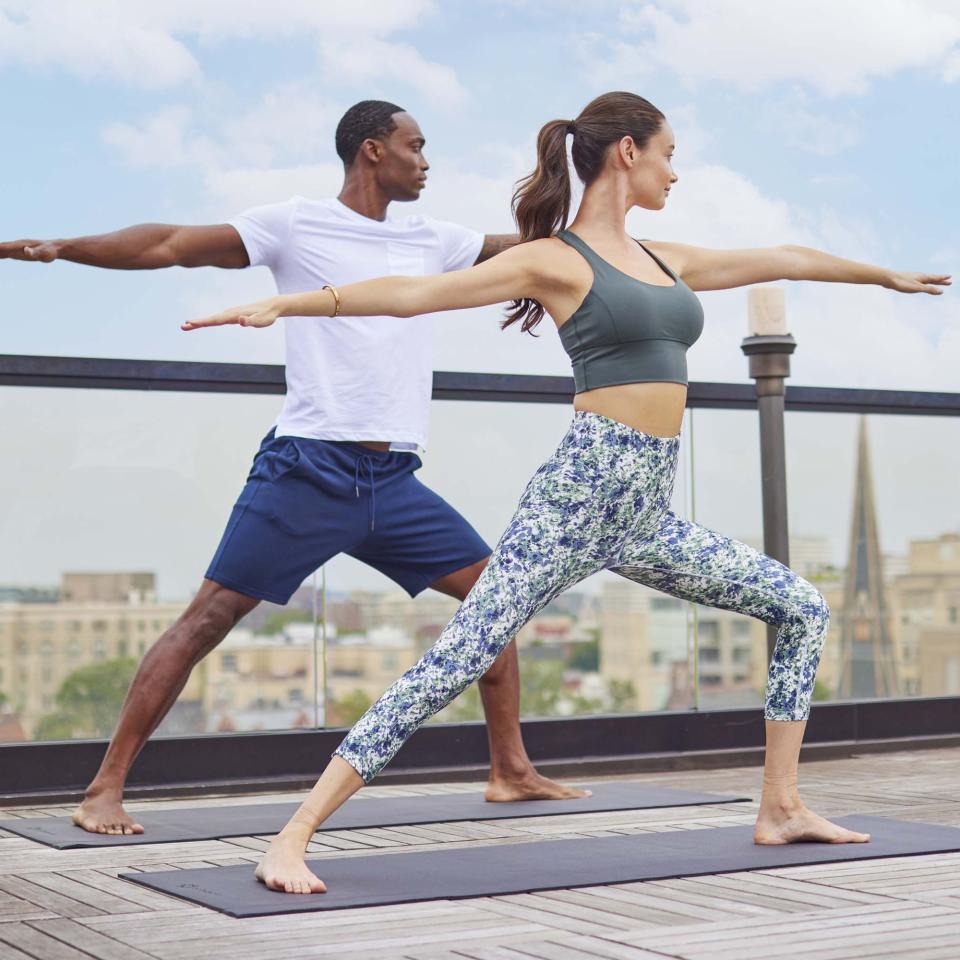 A couple doing yoga on the rooftop of Viceroy Washington DC