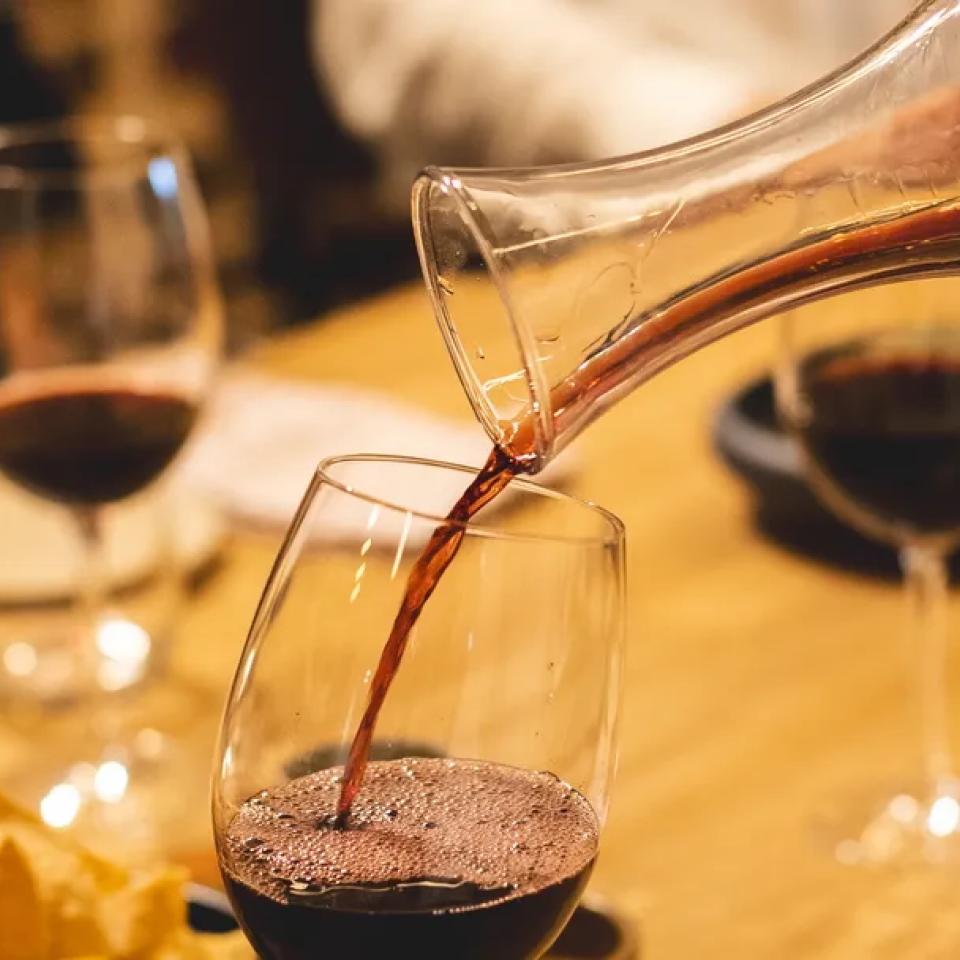Red wine is poured into a glass