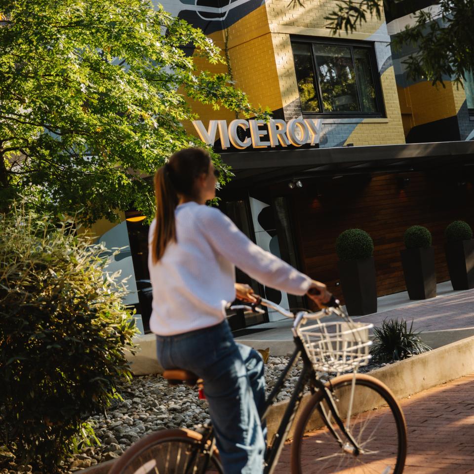 A cyclist rides their bike along a path outside Viceroy Washington DC