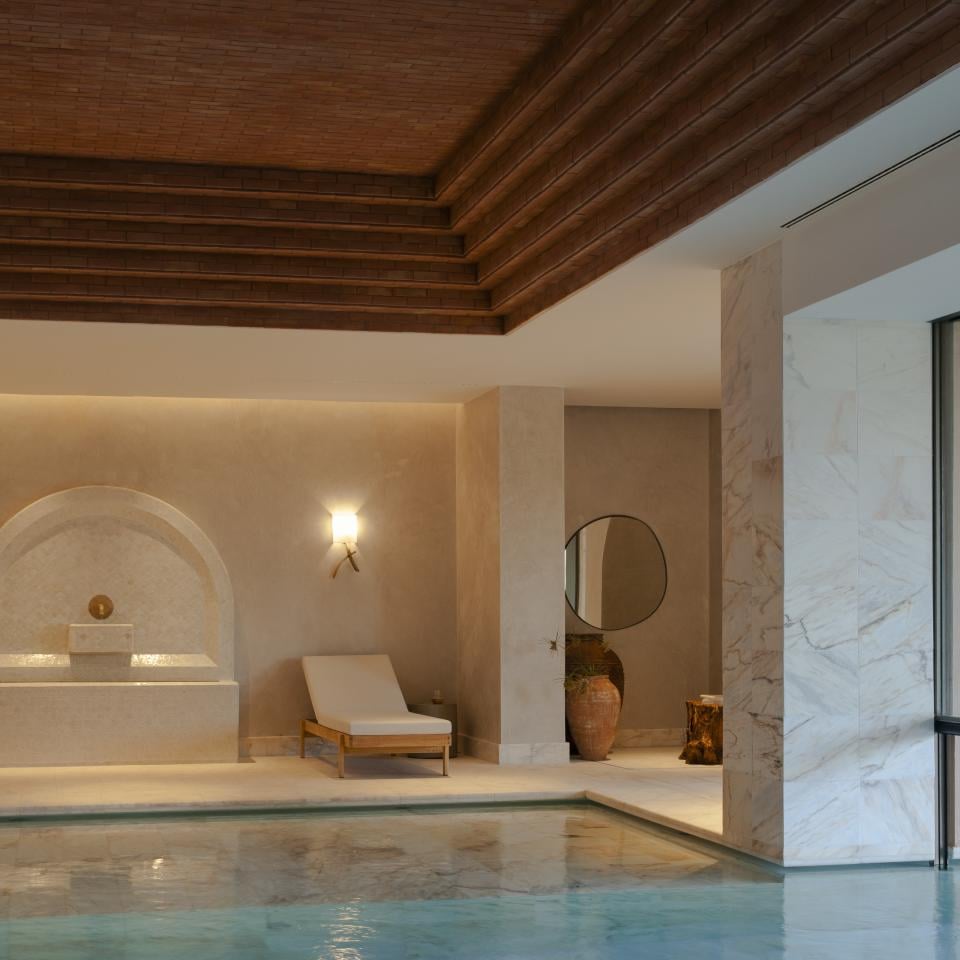 Pool area with lounge chair and water fountain