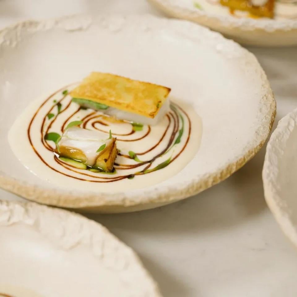 A refined dish prepared by a Michelin-rated chef.