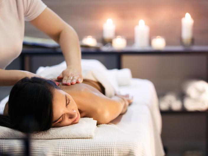 woman lays on table while getting massage