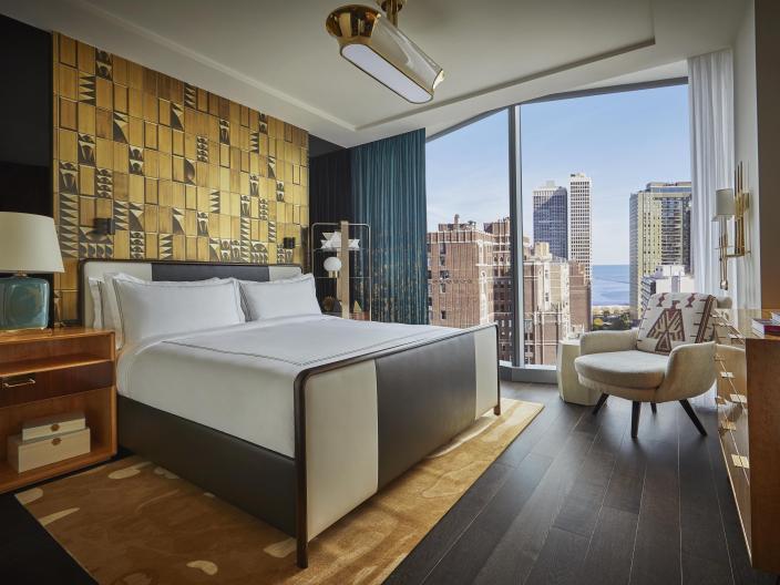 bedroom with king bed and view of the city
