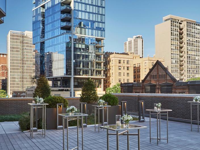 outdoor rooftop venue set with high square tables