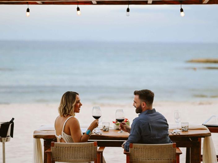 couple eating dinner on the beach