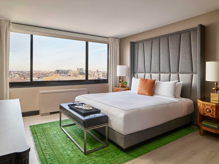 bedroom with king bed and a green rug