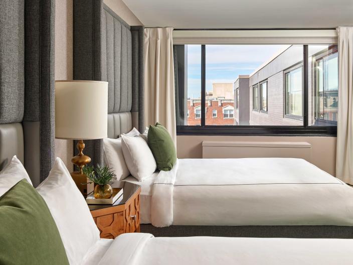 Bedroom with two queen beds and a view of the hotel