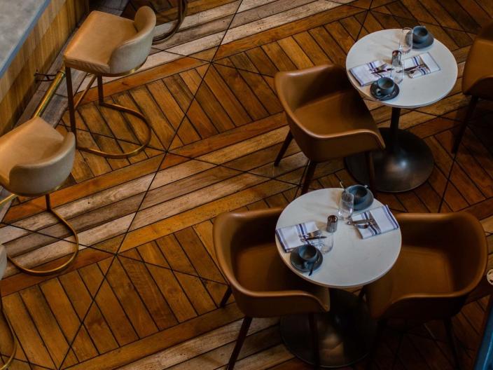 Aerial view of tables on a parquet floor at Somerset restaurant, at Viceroy Chicago