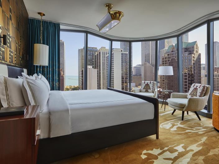 A suite at Viceroy Chicago with floor to ceiling windows and a beautiful view of Chicago 