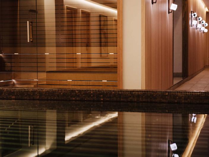 A wading pool in front of a row of relaxation rooms at Viceroy Kopaonik Serbia spa