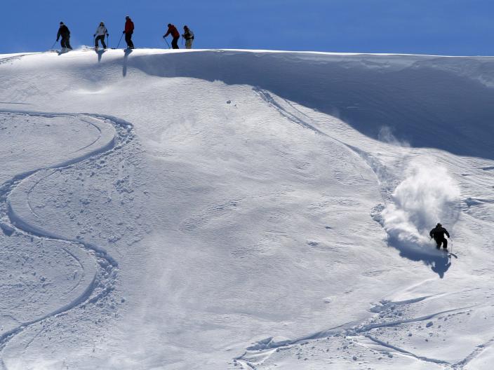 A skiier descends off-piste on an unkempt slope in the Kopaonik mountains