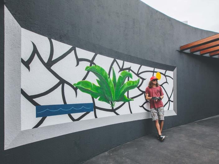 Artist Spencer Mar Guilburt posing with Deep Roots