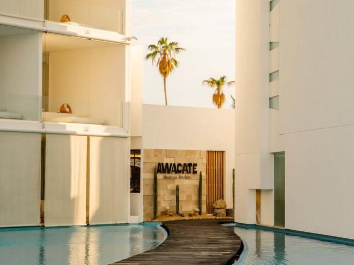 The exterior of Awacate restaurant at Viceroy Los Cabos, at the end of a pathway between two ponds