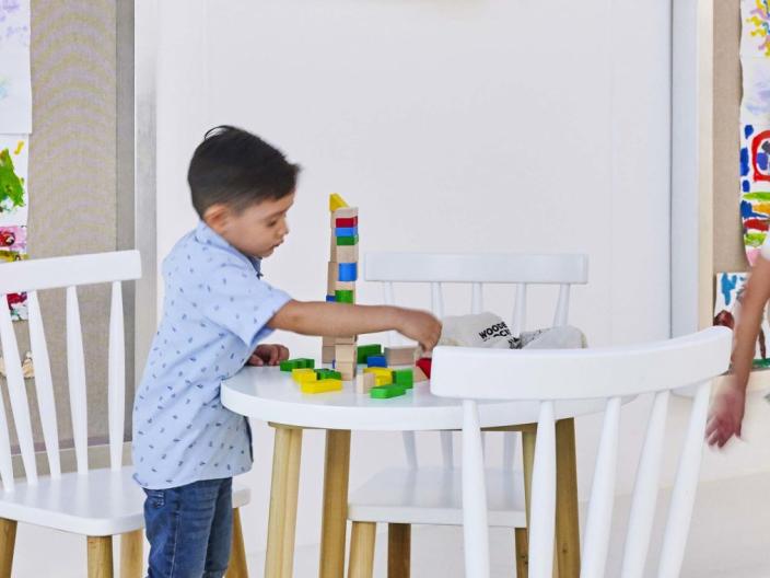 Kids playing with blocks and a chalk board