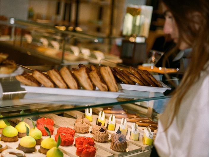 A woman looks at the assortment of pastries at Cafe Central