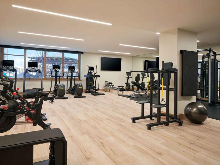 The fitness center at Viceroy Snowmass, with treadmills, exercise bikes and a workout mat