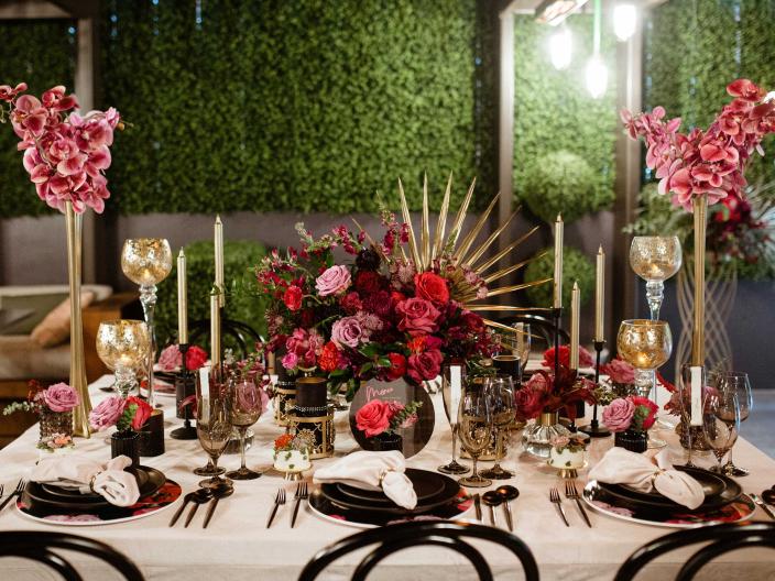 An elegant place setting with large floral centerpieces on a white tablecloth at Viceroy Washington DC