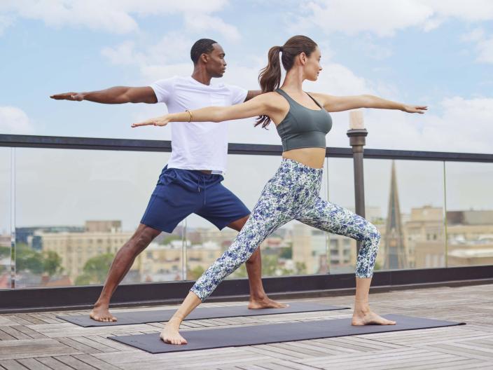 A couple doing yoga on the rooftop of Viceroy Washington DC