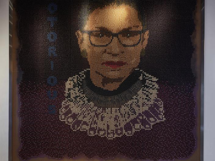 A portrait of Ruth Bader Ginsberg in a pixellated style