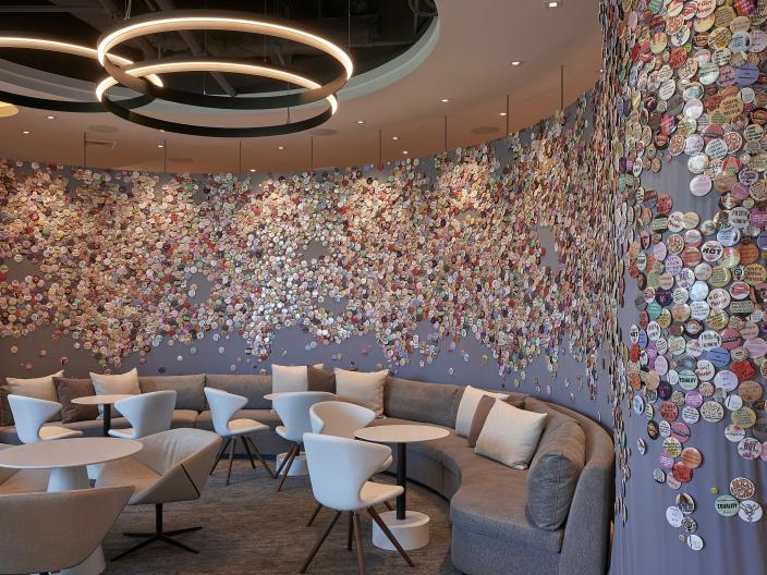 A mural made of buttons fastened to a curved wall
