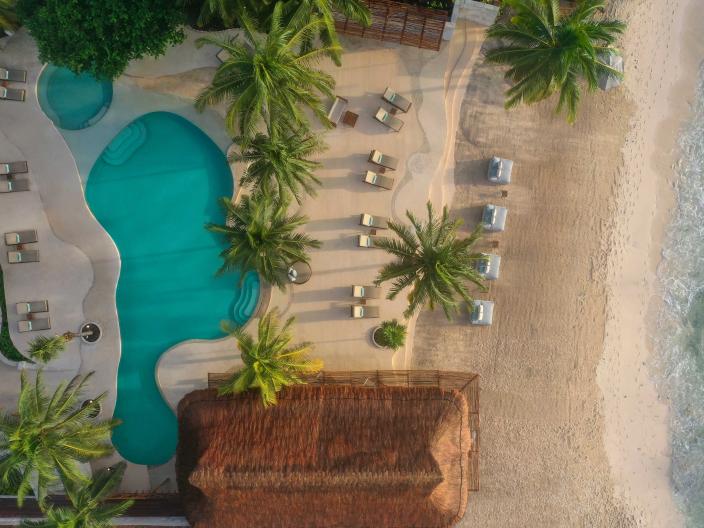 Overhead view of the beach, a pool, and accommodations at Viceroy Riviera Maya