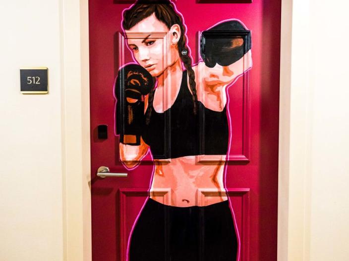 A hotel door painted with a female boxer