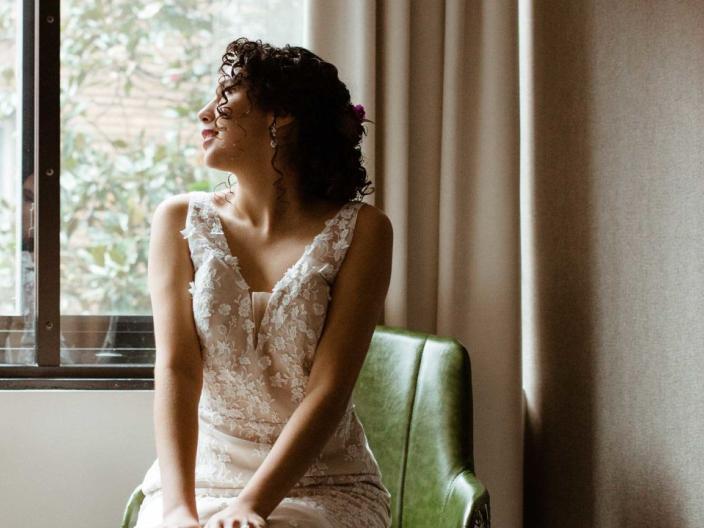 A beautiful bride in a wedding dress looking out a Viceroy Washington DC window