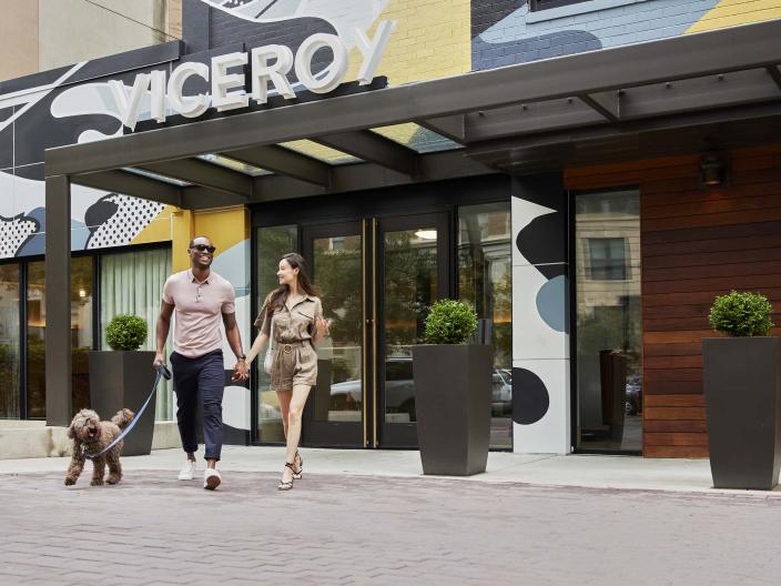 A couple walking a dog outside of Viceroy Washington DC