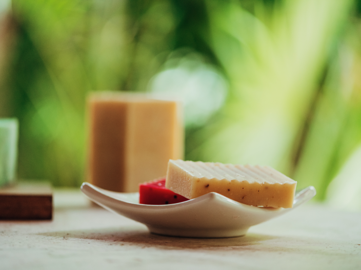 a variety of colored bars of soap sit on table