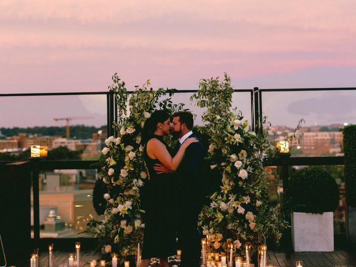 A couple dancing at their enagement party, on the rooftop patio of Viceroy Washington DC