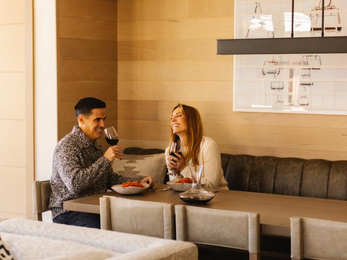 Two people enjoying a glass of wine in a restaurant 